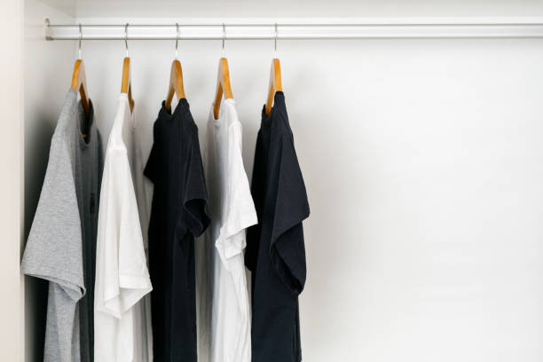istock Shirts on wooden hangers on a rail inside wardrobe 1388404562