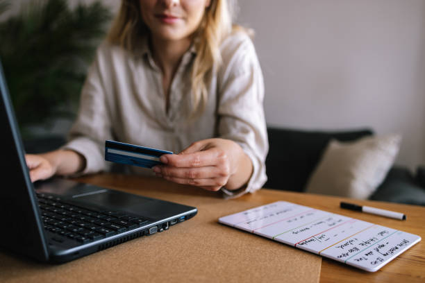 istock Woman Using Her Credit Card For Online Payments 1388404585