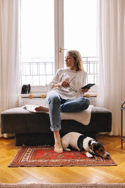 istock Woman Relaxing At Home Using Her Tablet Device 1388404675