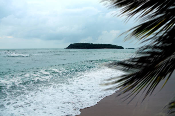istock Empty tropical seascape and small island over stormy sky 1388404826