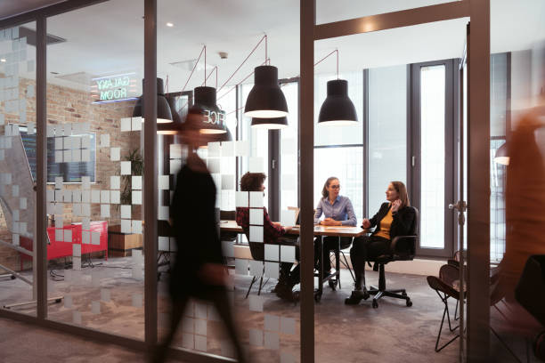 istock Successful team. Group of young multi-ethnic business people working and communicating together in creative office. Selective focus 1388405116