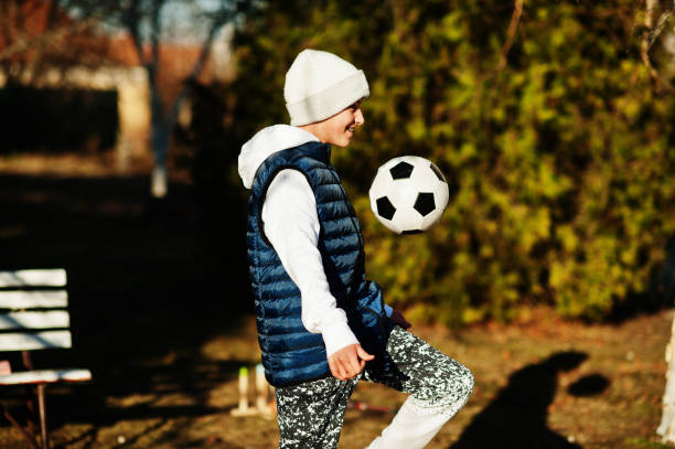 istock Boy play with the soccer ball in spring sunny day. 1388405180