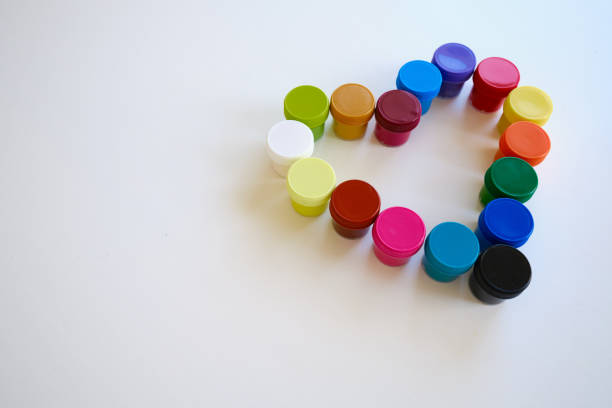 istock Jars with multi-colored paints in the shape of a heart. Creative background. Paint for drawing. Love postcard. Mock up 1388405413