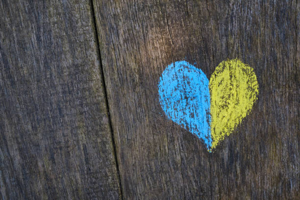 Yellow-blue heart drawn with crayons on a wooden background. Independence of Ukraine. Ukraine love concept. Crayons for drawing. creative background stock photo