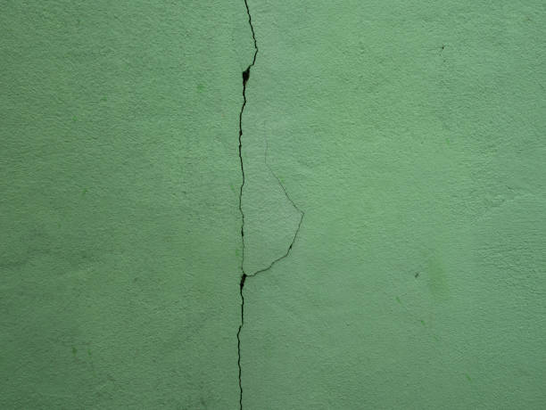istock The cracks in concrete wall. 1388405506