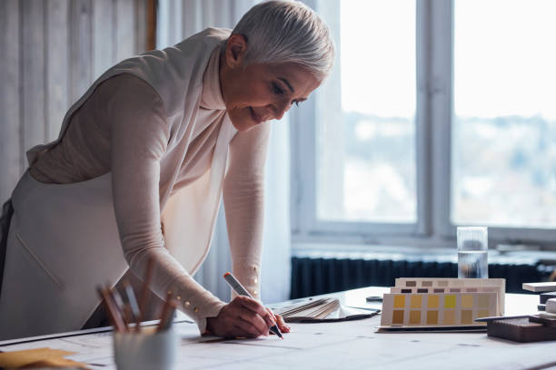istock Elegant Senior Woman Architect Working on her Project in the Office 1388405667
