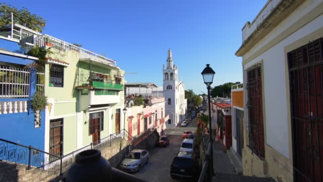 Movement forward along the fence on the Hostos street street. Beautiful view to Santuario Nuestra Señora de la Altagracia.