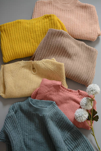 istock Various colors baby sweaters on dark gray background 1388409588