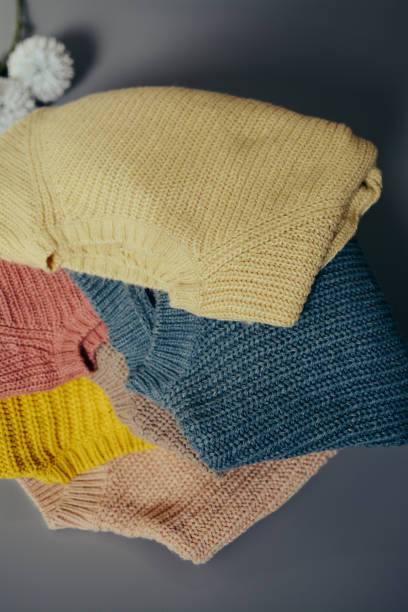 istock Various colors baby sweaters on dark gray background 1388409623