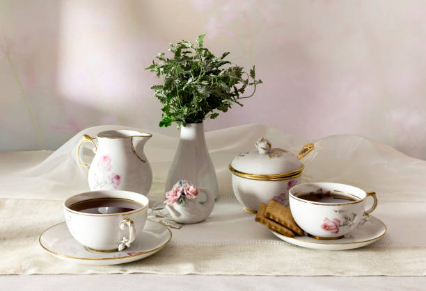 istock Cups with tea, cookies and a bouquet on the table close-up. 1388410716