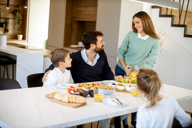 istock Young mother preparing breakfast for her family in the kitchen 1388410862