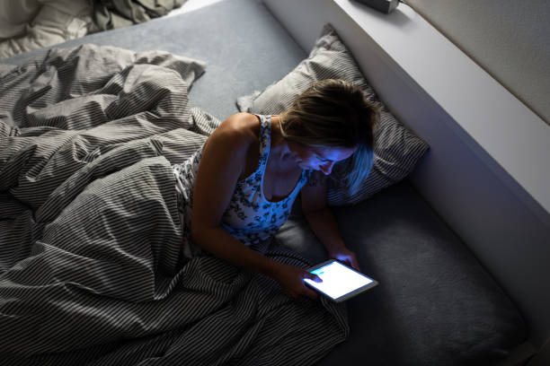 istock Pretty, middle-aged woman using her tablet computer before sleep in bed in the evening 1388410981