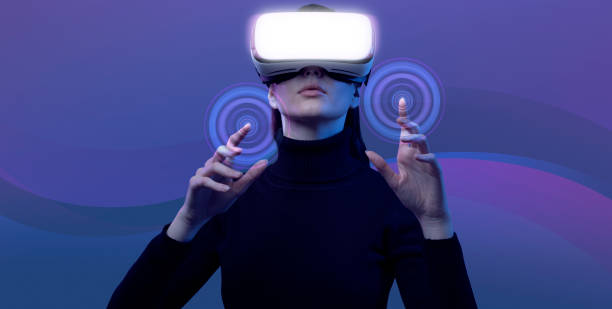 Woman wearing a VR headset and interacting with virtual reality stock photo