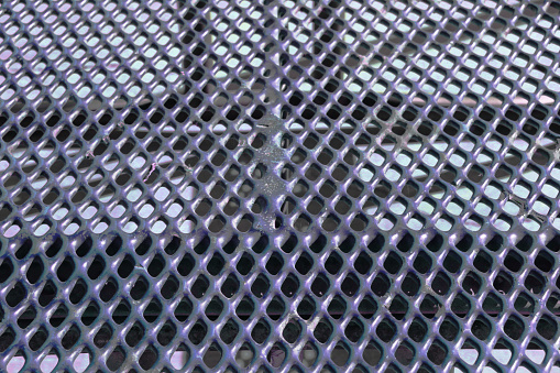 a steel metal vent grate drain drainage holes industrial floor iron flooring