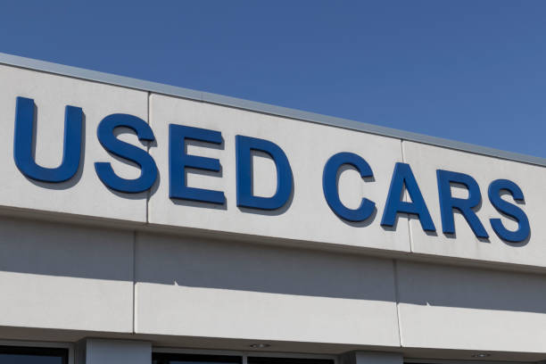 Used Car sign at a pre-owned car dealership. As supplies of new cars dwindle, used cars become more popular. stock photo