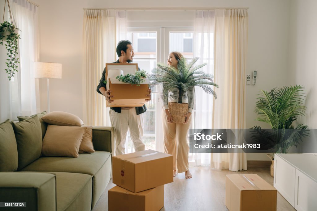 Asian couple moving in new house. Asian couple moving new house for the new change in lives. Home Ownership Stock Photo