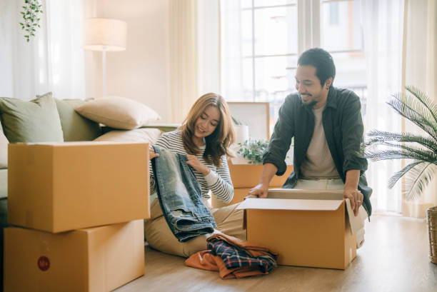 Asian couple moving in new house. stock photo