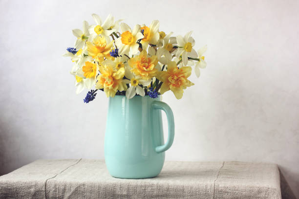 istock bouquet of yellow daffodils in a blue jug 1388414551