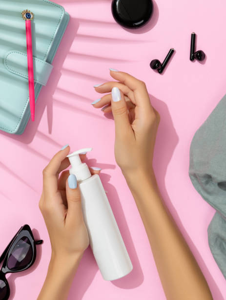 istock Womans hands cosmetics and accessories on pink background 1388414641