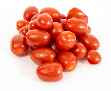 Grape or cherry tomatoes on a white background.