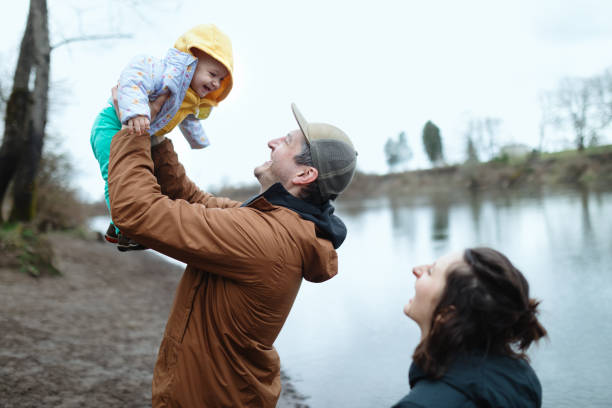 istock Family Outdoors In Nature Setting With Their Baby 1388415790