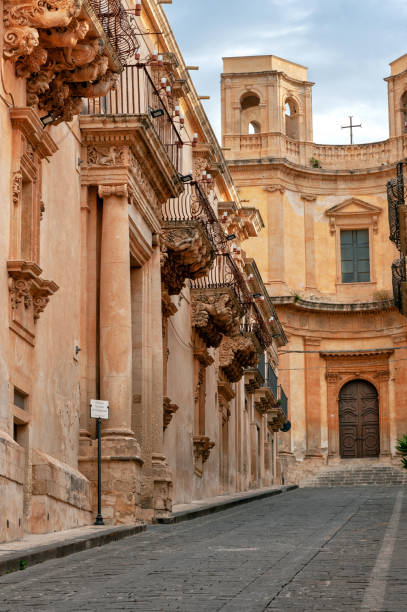 Noto (SR) Noto, Siracusa district, Val di Noto, Sicily, Italy, Europe, Nicolaci di Villadorata palace, baroque balconies, in the background the church of Montevergini noto sicily stock pictures, royalty-free photos & images
