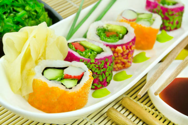 Various Sushi rolls Masago Classic Roll and Veggie California Roll with soya sauce, ginger, wasabi and wakame salad