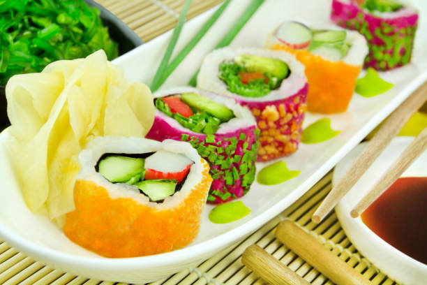 various sushi rolls masago classic roll and veggie california roll with soya sauce, ginger, wasabi and wakame salad - buffet japanese cuisine lifestyles ready to eat imagens e fotografias de stock
