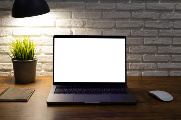 istock workspace with laptop computer with blank white screen mockup, and office supplies on a wooden desk 1388417848