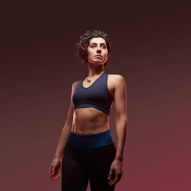 Strong confident athletic sportswoman standing Strong confident athletic sportswoman standing sportsperson stock pictures, royalty-free photos & images