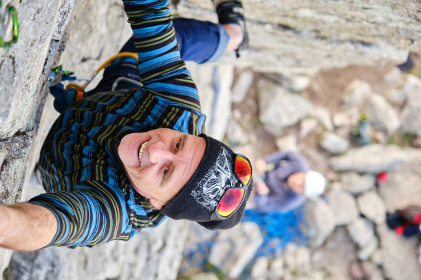istock A Happy mature climber hanging on cliff 1388420274