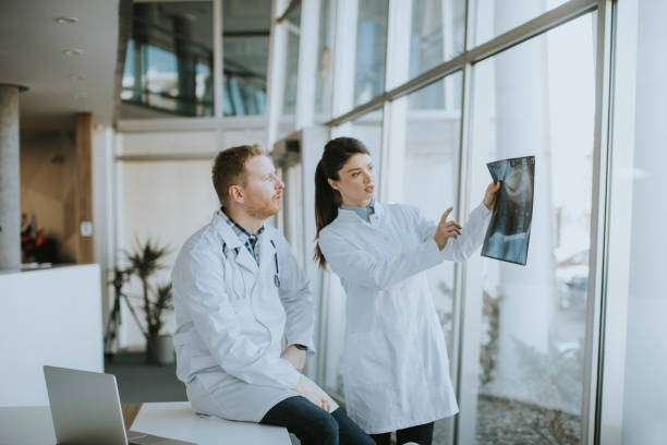 istock Team of young doctors examining x-ray image in the office 1388420305