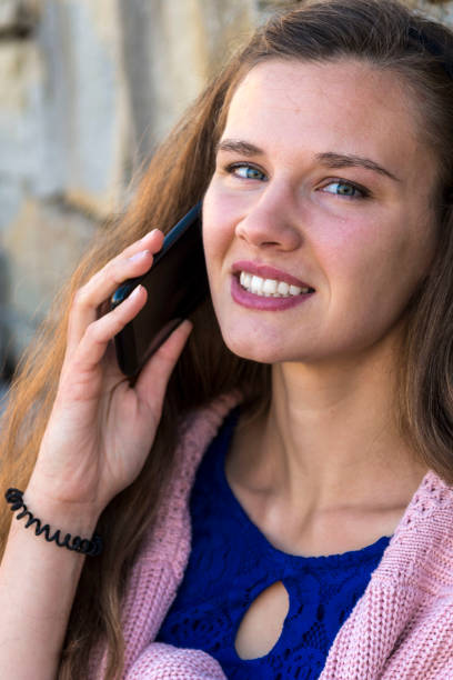 A young woman is talking on the phone.