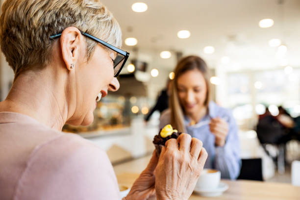 istock Women talking over cupcake and coffee 1388421907
