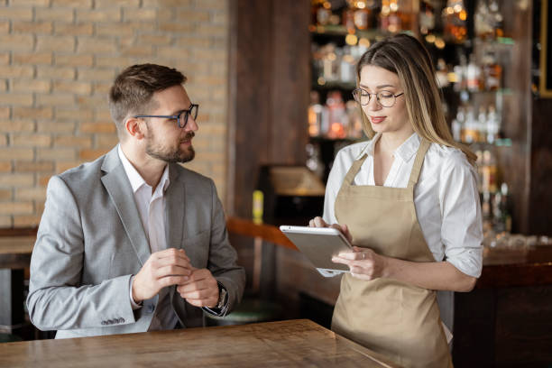 istock Female Waiter Using Digital Tablet to Take an Order 1388421926