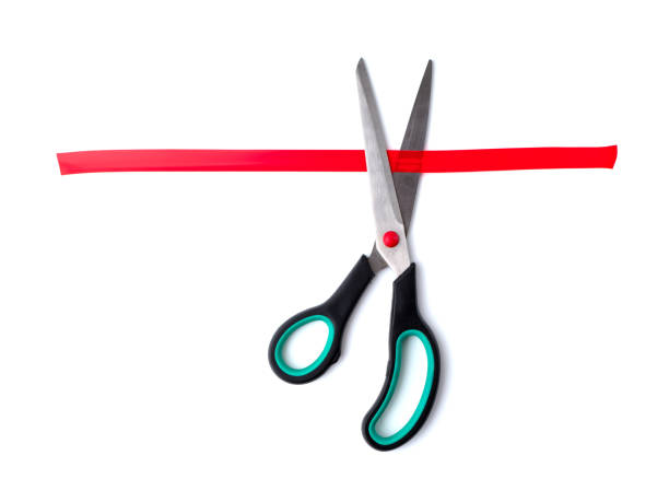 istock Scissors cutting red sticky tape on a white background. View from above 1388422018