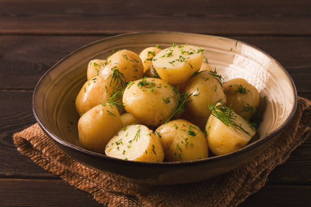 istock Fresh Cooked, new potatoes,with dill, on a wooden table, selective focus. close-up, toning, no people, 1388423082