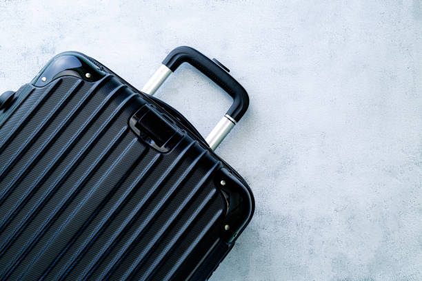 istock black travel bag,Black luggage set on dark background, top view image, flat lay composition. Travel minimalist concept, black and dark classic baggage mockup, small and big. Suitcase accessory set, journey 1388423108