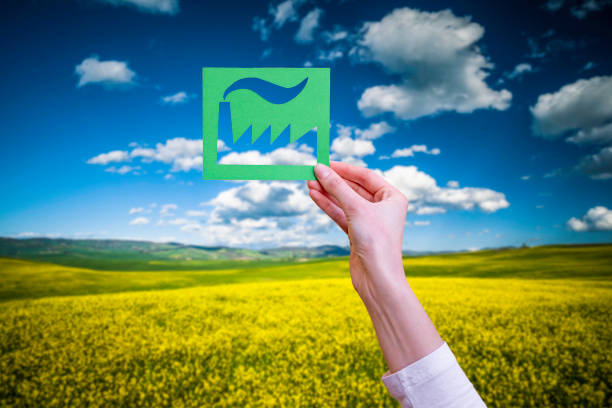 Hand holds green industry symbol stock photo