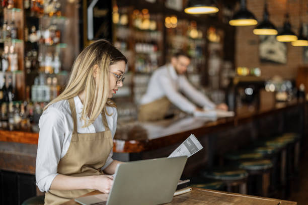 istock Female cafe owner going through financial paperwork 1388423195