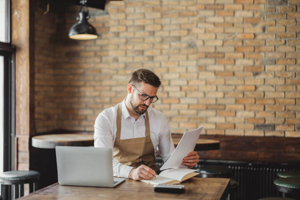 istock Coffee Shop Owner doing some Paperwork 1388423318
