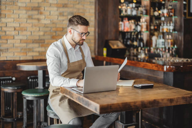 istock Coffee Shop Owner doing some Paperwork 1388423375