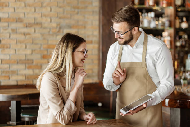 istock Male Waiter Using Digital Tablet to Take an Order 1388423579