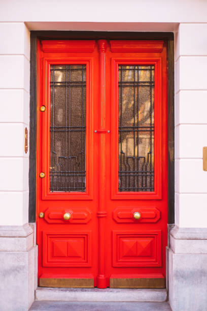 Residence front entrance with bright red outside door.