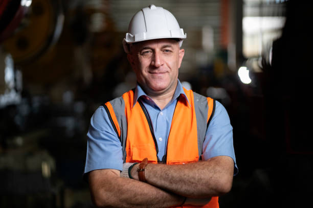 Smart portrait, male senior engineer standing with his arms crossed confidently. stock photo