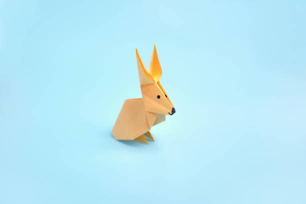 istock Origami Bunny. Step-by-step photo instruction on a blue background. Easter bunny. DIY concept. Step17. Rabbit 2023 1388426048