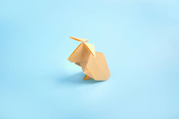 istock Origami Bunny. Step-by-step photo instruction on a blue background. Easter bunny. DIY concept. Step16. Rabbit 2023 1388426086