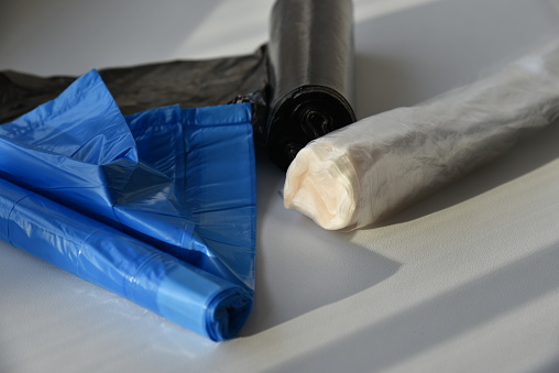 Plastic garbage bags in rolls on a white background