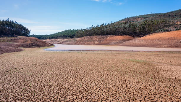 Landscape of low water and dry land in advance, severe drought in the reservoir of Portugal. Ecological disaster, soil dehydration. desert, drought, stock photo