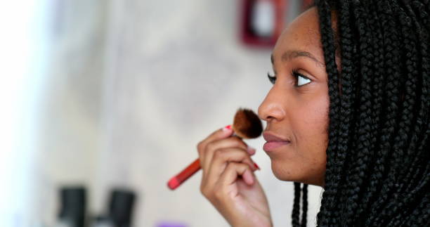 istock African black teen applying make-up 1388430921